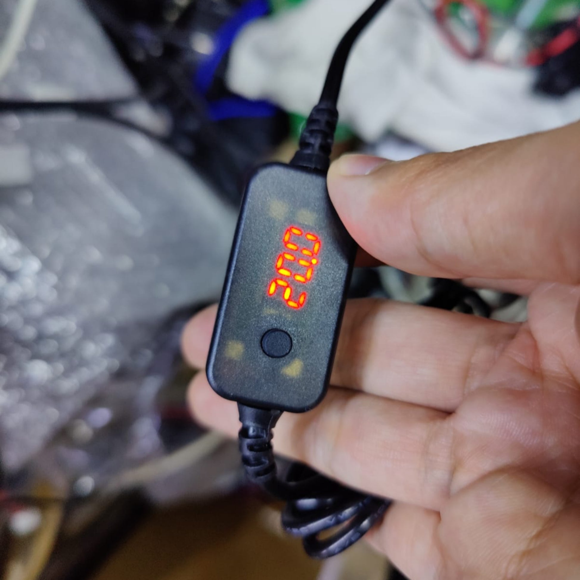 Close-up of USB-C to DC voltage adjustable cable with digital display showing 20V.