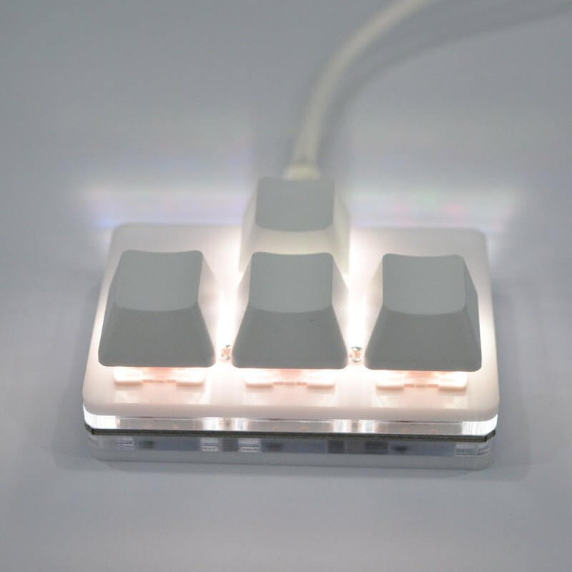 USB multifunctional mini keypad with illuminated keys for easy access and macro functions.