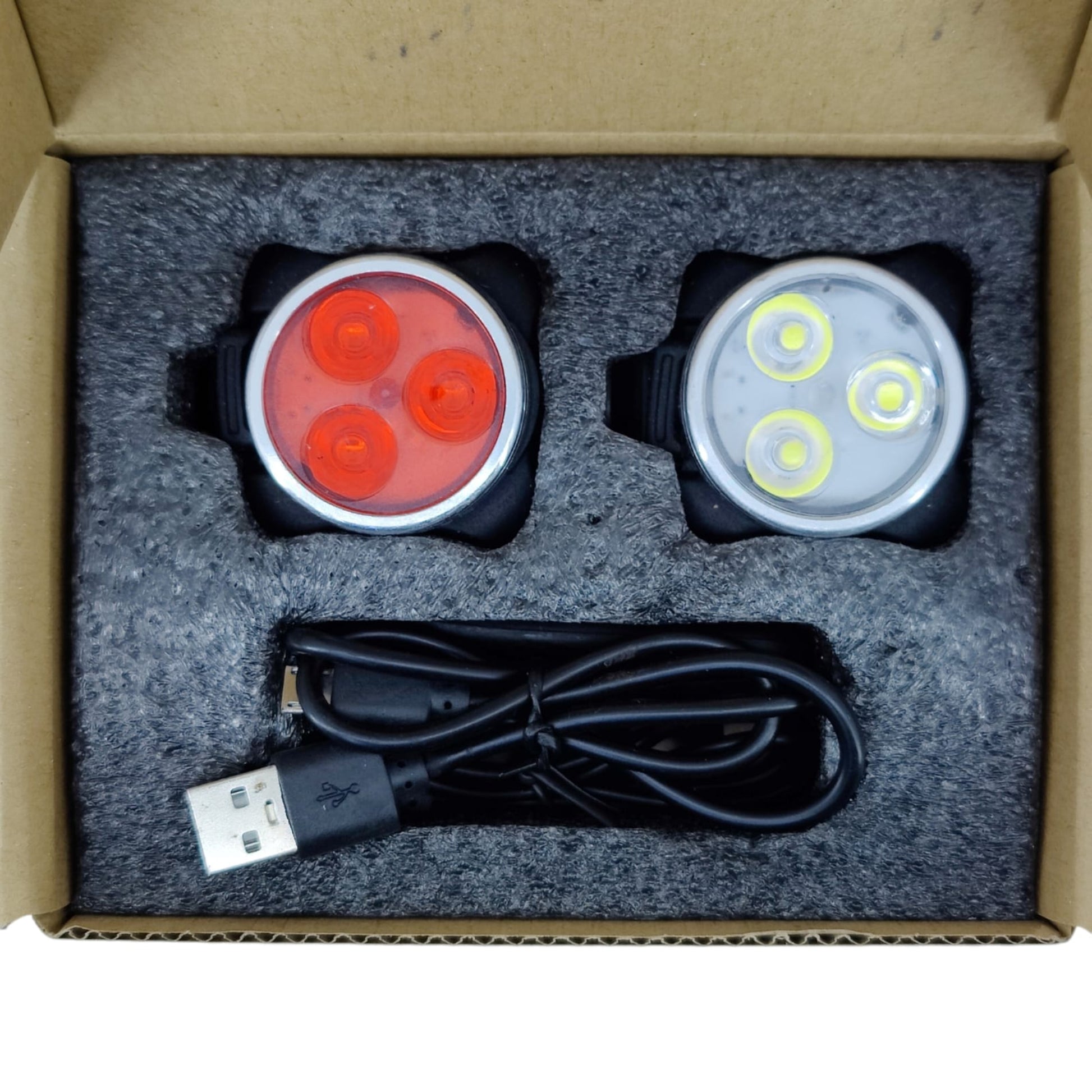Box set of USB rechargeable bike lights including white front light, red rear light, and charging cable.