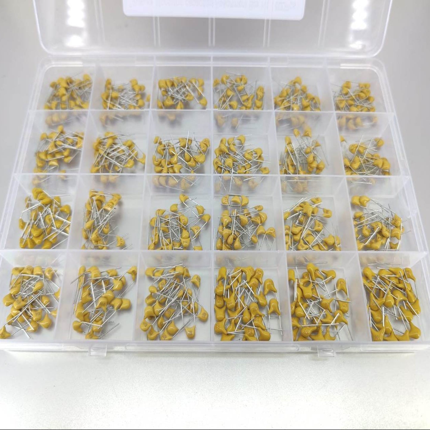 Detailed view of yellow through-hole monolithic ceramic capacitors.