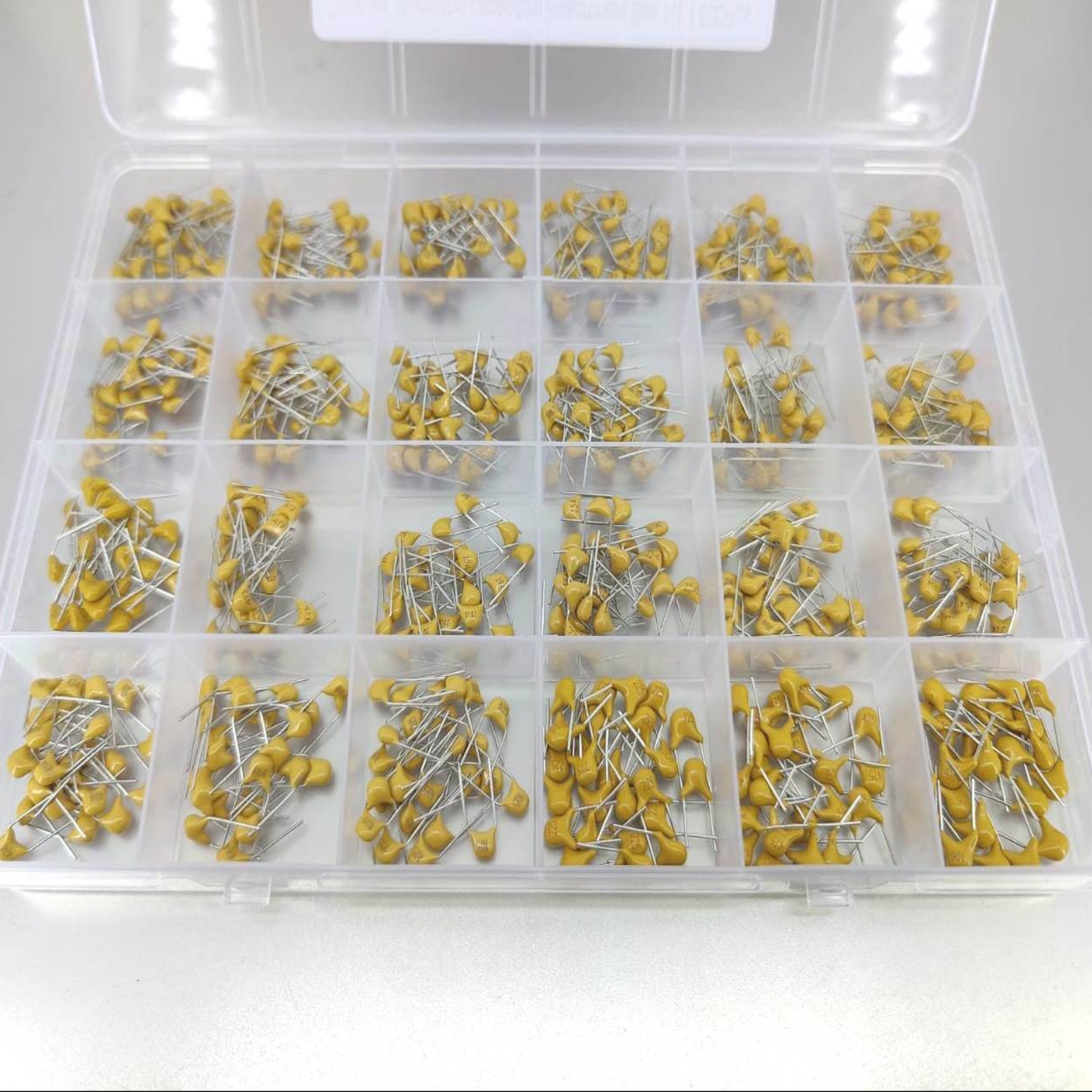 Detailed view of yellow through-hole monolithic ceramic capacitors.