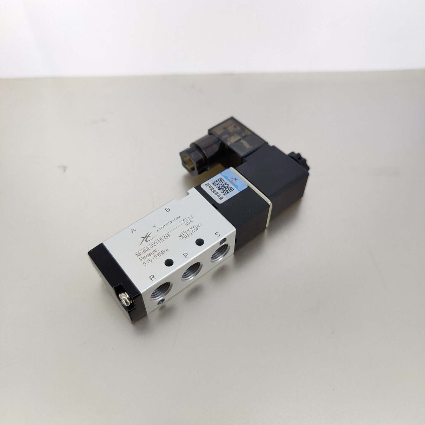 Top view of the 4V110-06 solenoid valve showing the standard 1/8 inch BSP A and B outlet ports.