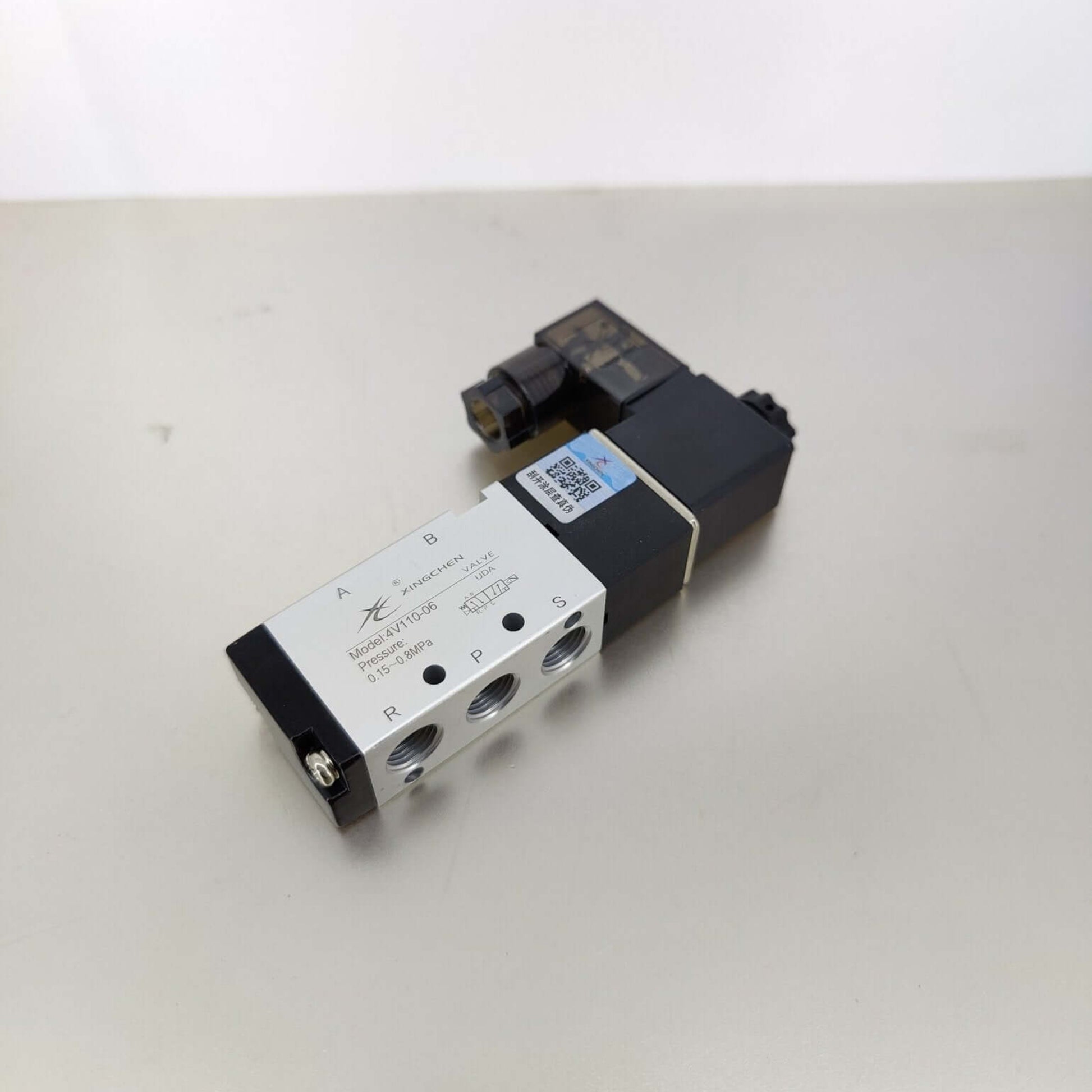 Top view of the 4V110-06 solenoid valve showing the standard 1/8 inch BSP A and B outlet ports.