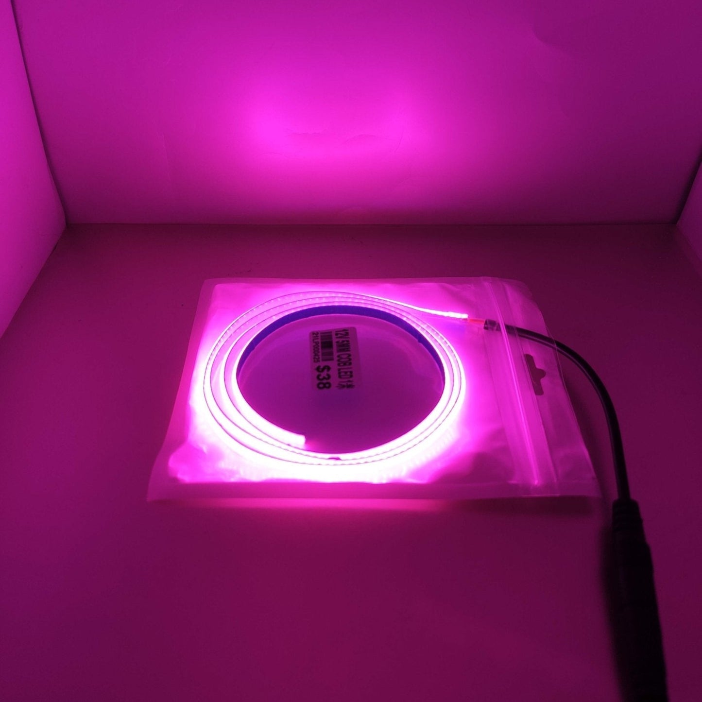12V 5mm LED light strip in pink color, flexible and decorative, packaged for easy use.