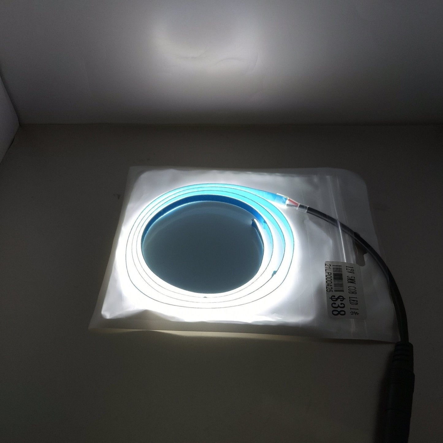 12V 5mm LED light strip on a coil inside packaging, ideal for room and car decoration.