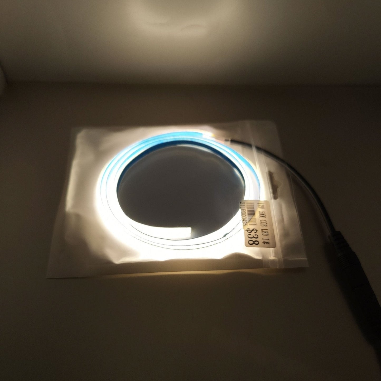 12V 5mm LED light strip in packaging, flexible blue illumination for room and car decoration.