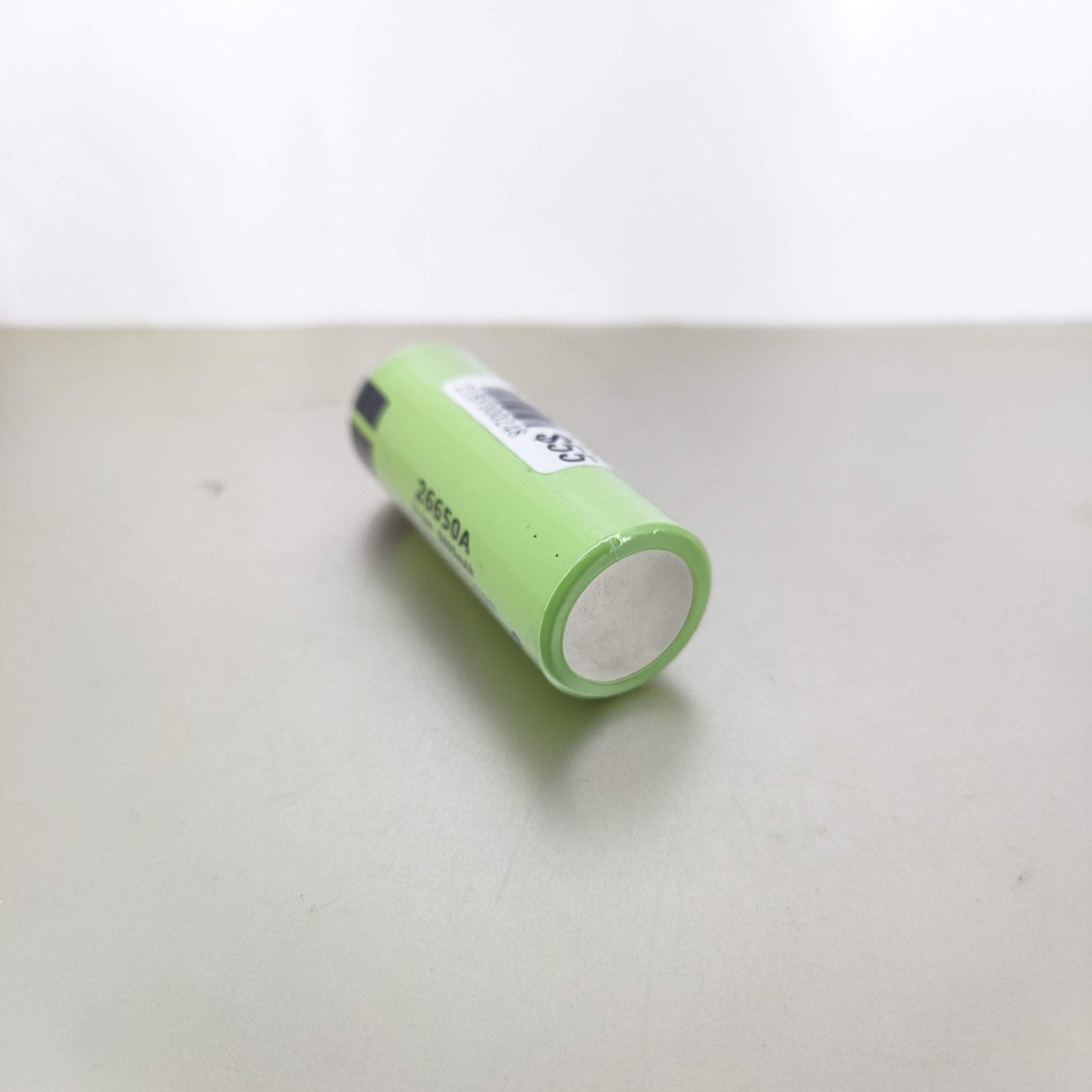 26650 rechargeable Li-ion battery on a flat surface, featuring 3.7V and 5000mAh specifications.