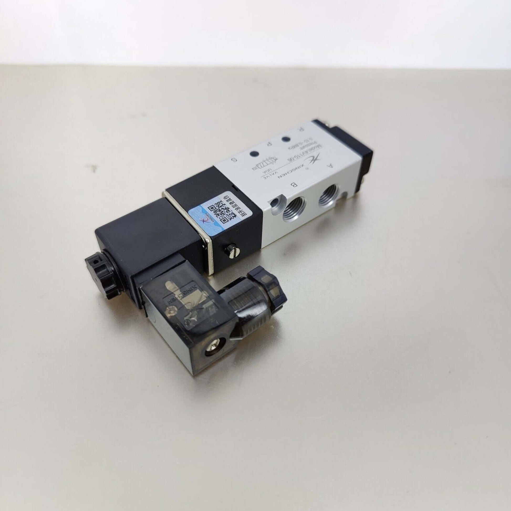 Bottom view of the aluminum pneumatic valve displaying the P, R, and S threaded ports for air intake and exhaust.