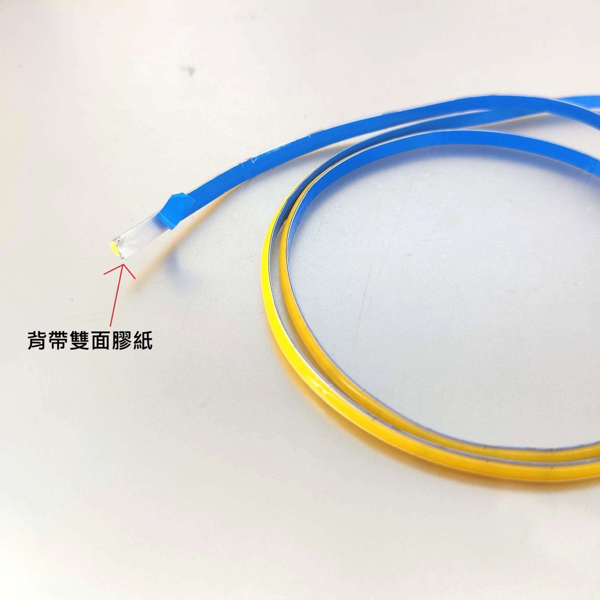 Close-up of blue and yellow flexible wire with connector end, ideal for electrical applications.