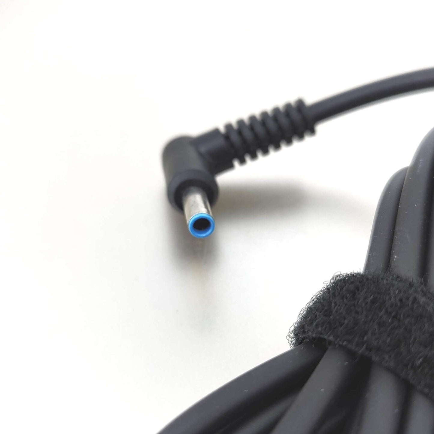 HP 45W 19.5V 2.31A Laptop Charger with 4.5x3.0mm Connector blue-tipped cable end close-up.