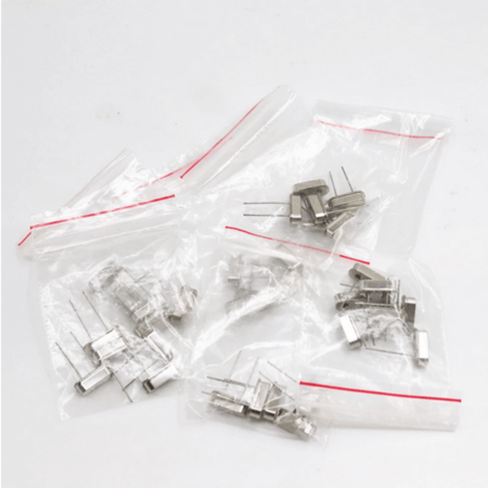 Crystal oscillator components in sealed bags, part of a 35-piece electronic kit for DIY projects.