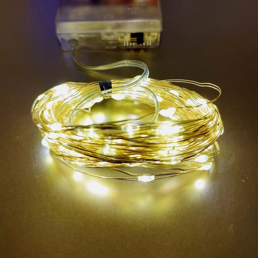Warm white LED string lights on copper wire, battery-powered for festive decoration indoors and outdoors.