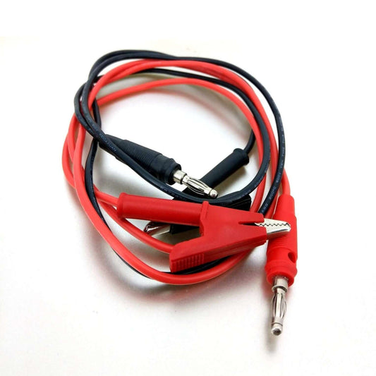 Coiled red and black alligator clip to banana plug test leads on white.