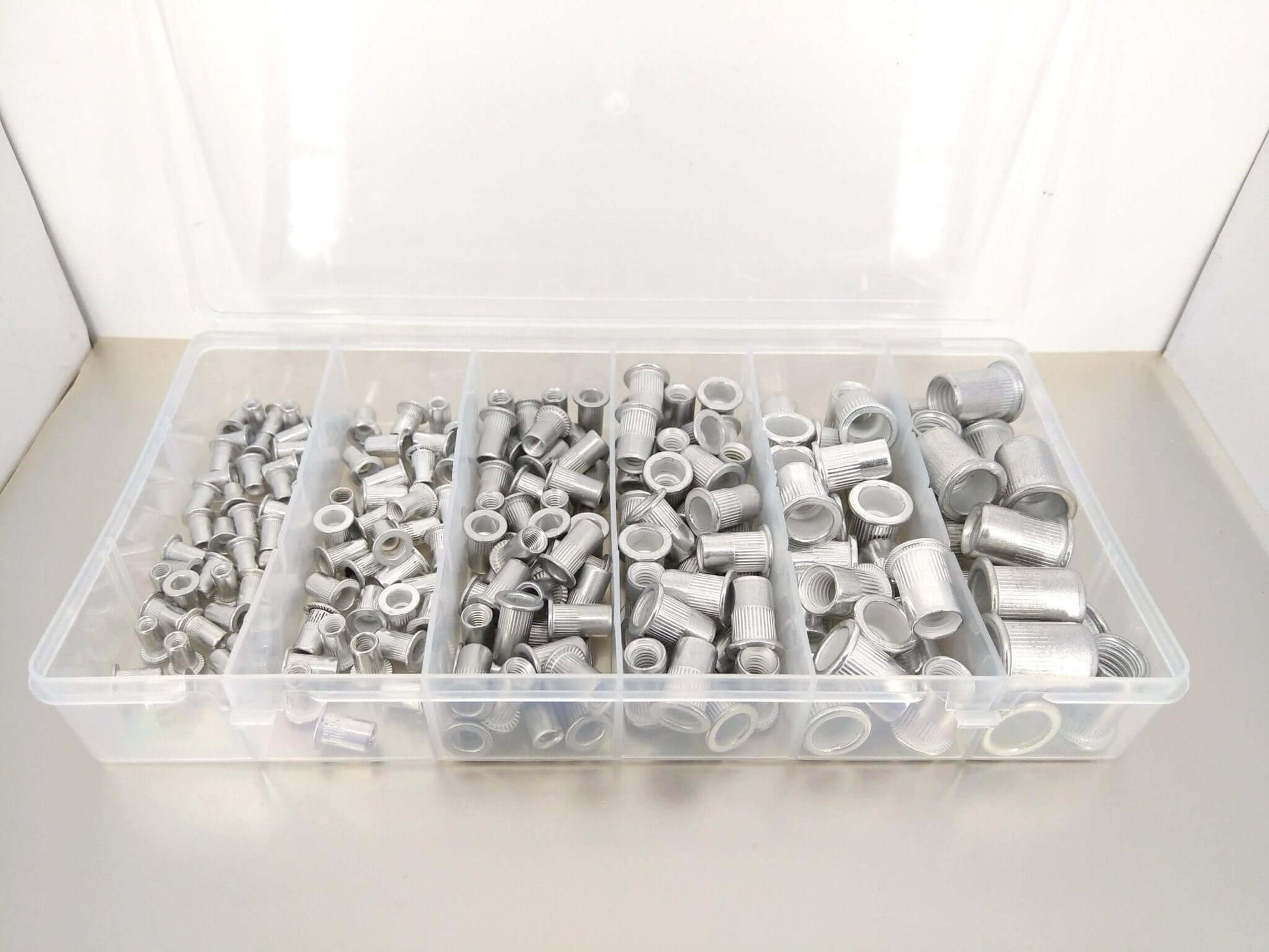 190-piece Aluminum Rivet Nut Kit displayed in a clear storage box, featuring various sizes of threaded inserts.