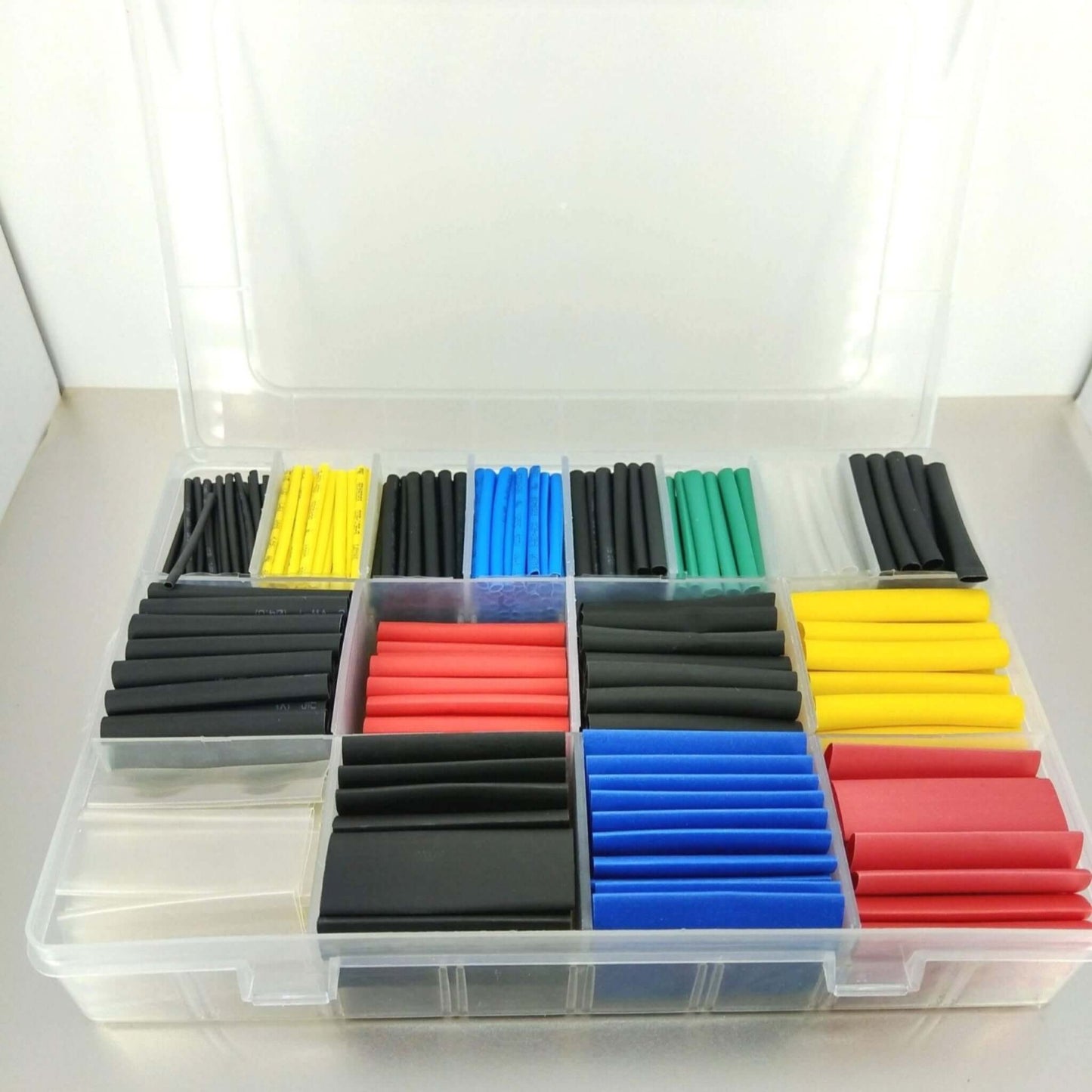 580PC heat shrink tubing kit in a clear storage box featuring assorted colors and sizes for cable management and protection.
