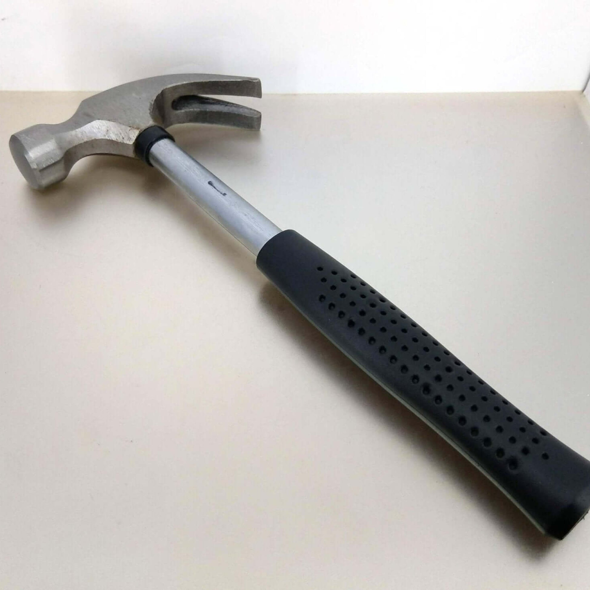Angled view of the mini claw hammer showing the nail pulling claw