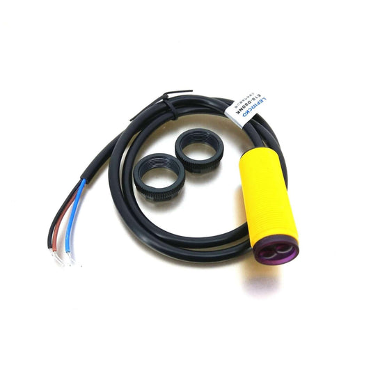 E18-D80NK adjustable infrared sensor with yellow casing and wiring, includes mounting rings for installation.