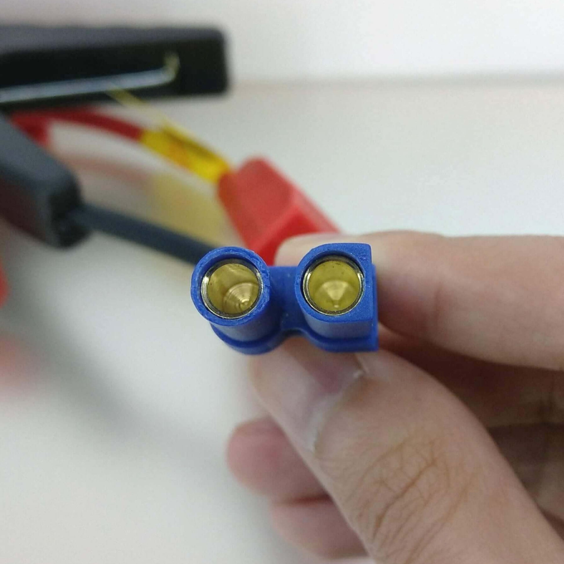 Close-up of EC5 connector showing gold terminals for alligator clip jumper cables.