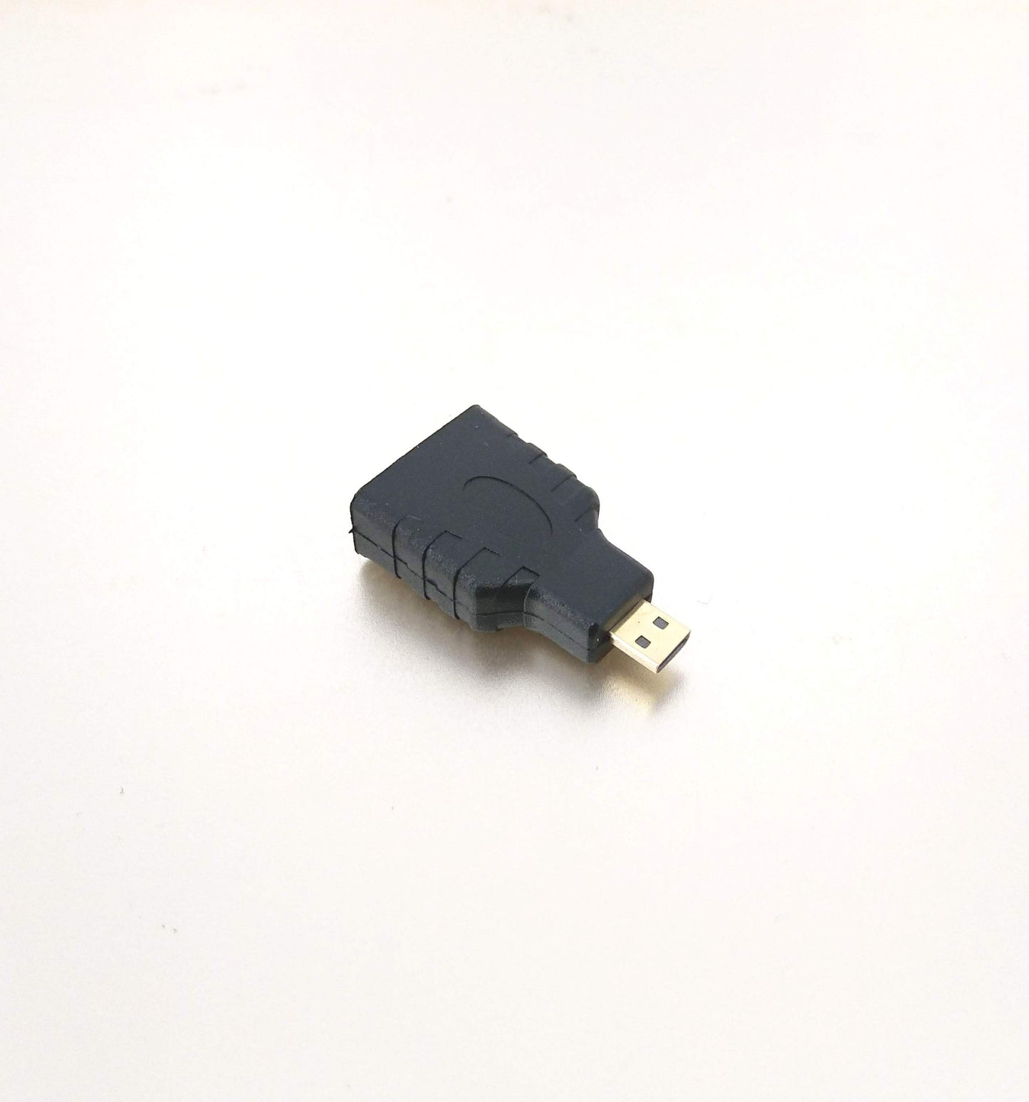Black Micro HDMI (Type D) Male to HDMI (Type A) Female adapter for connecting portable devices to HDTVs.