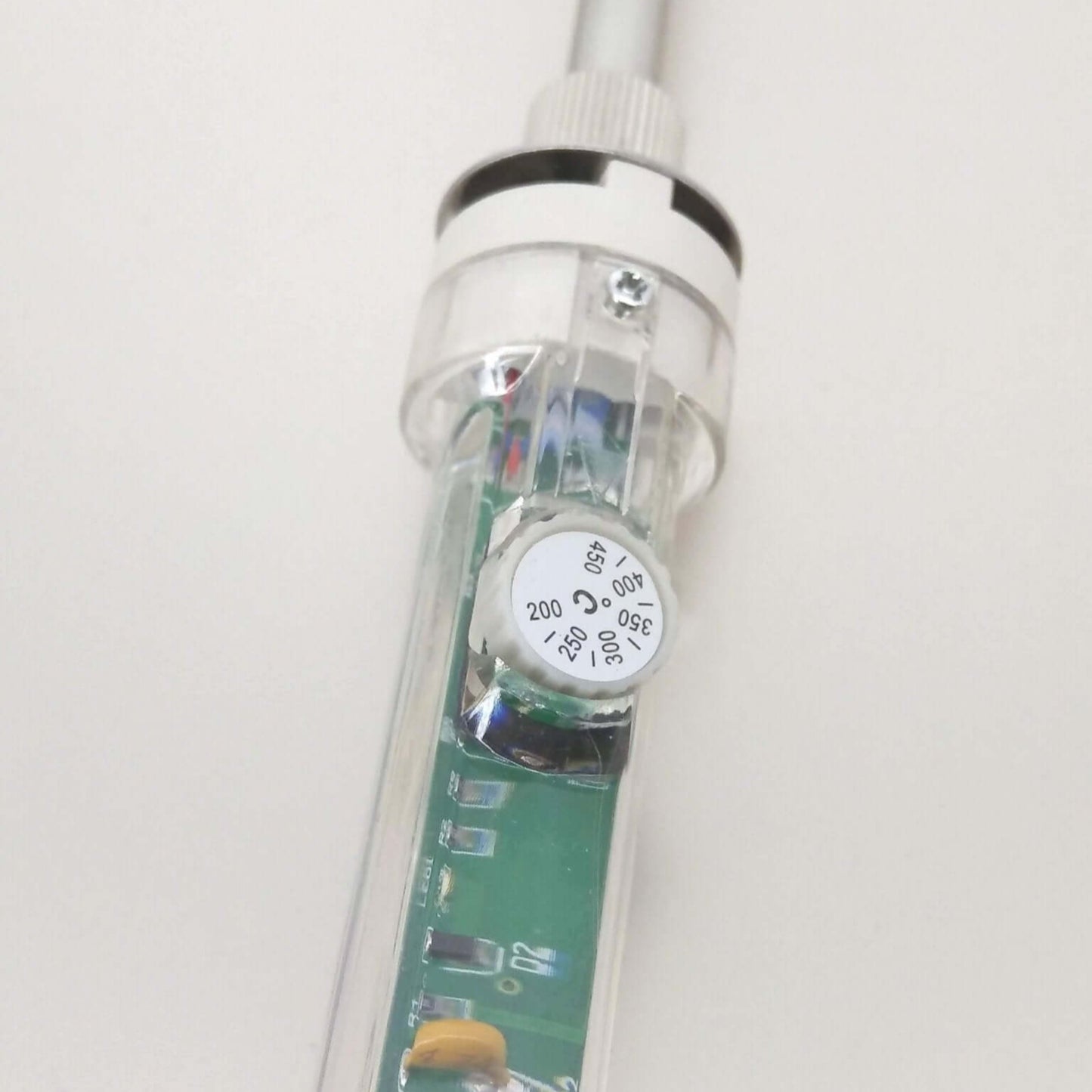 Close-up of the adjustable temperature knob on a 60W soldering iron with visible circuit board details.