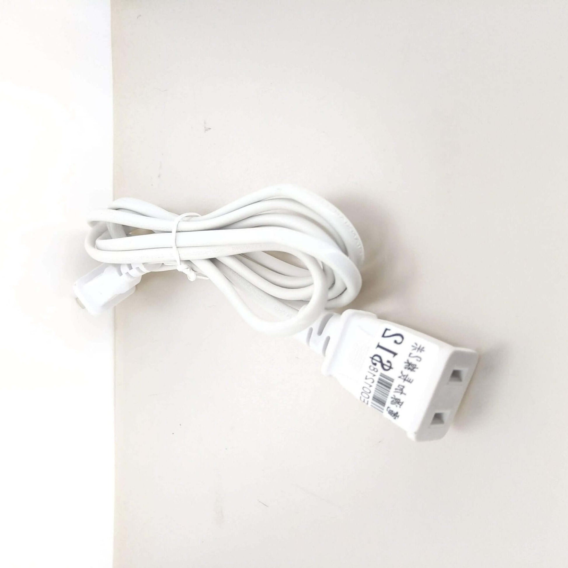 Close-up of US 2-prong male and female power extension cable ends for secure connection.