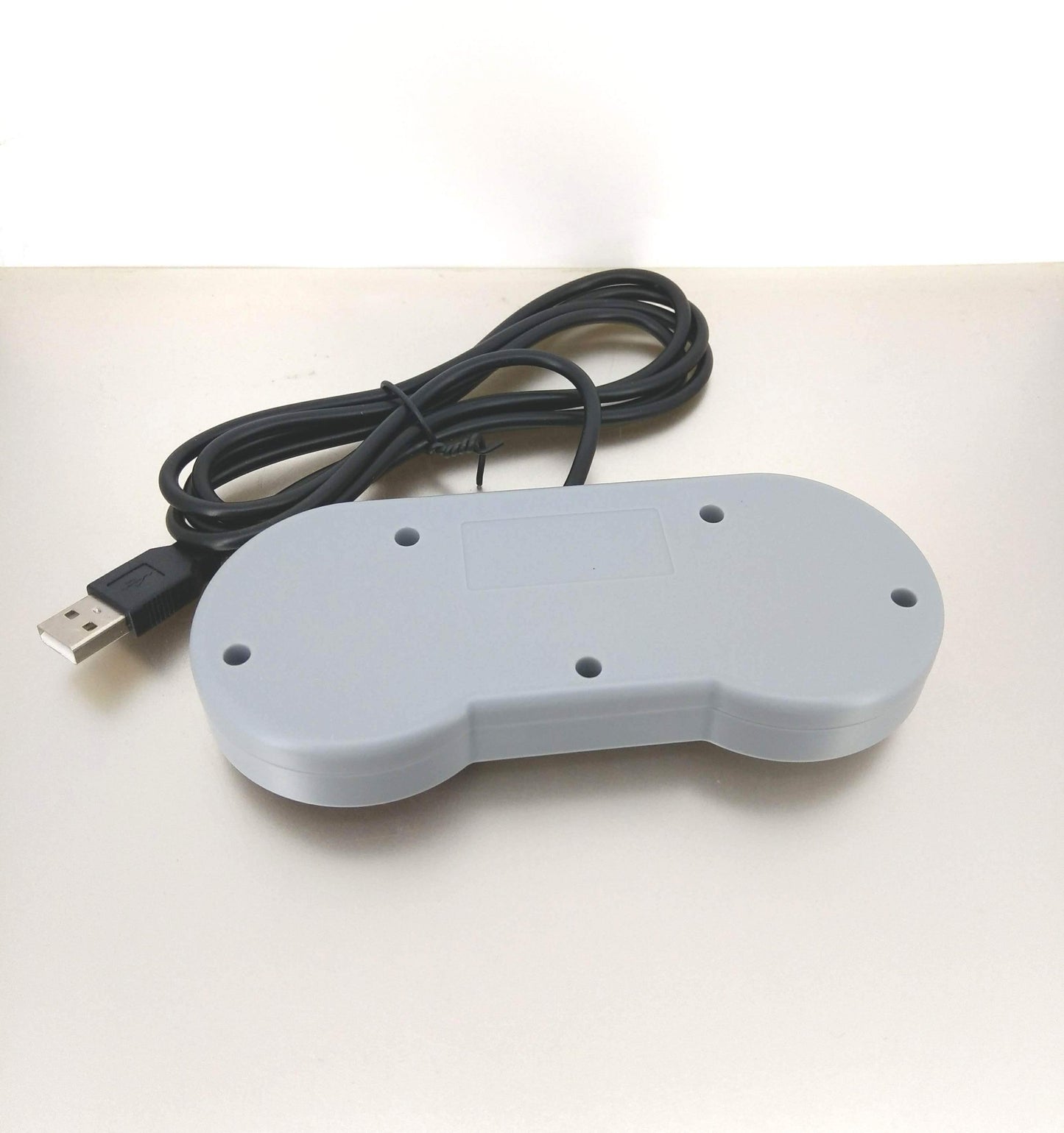 Back view of USB retro gaming controller, showing USB cable and ports