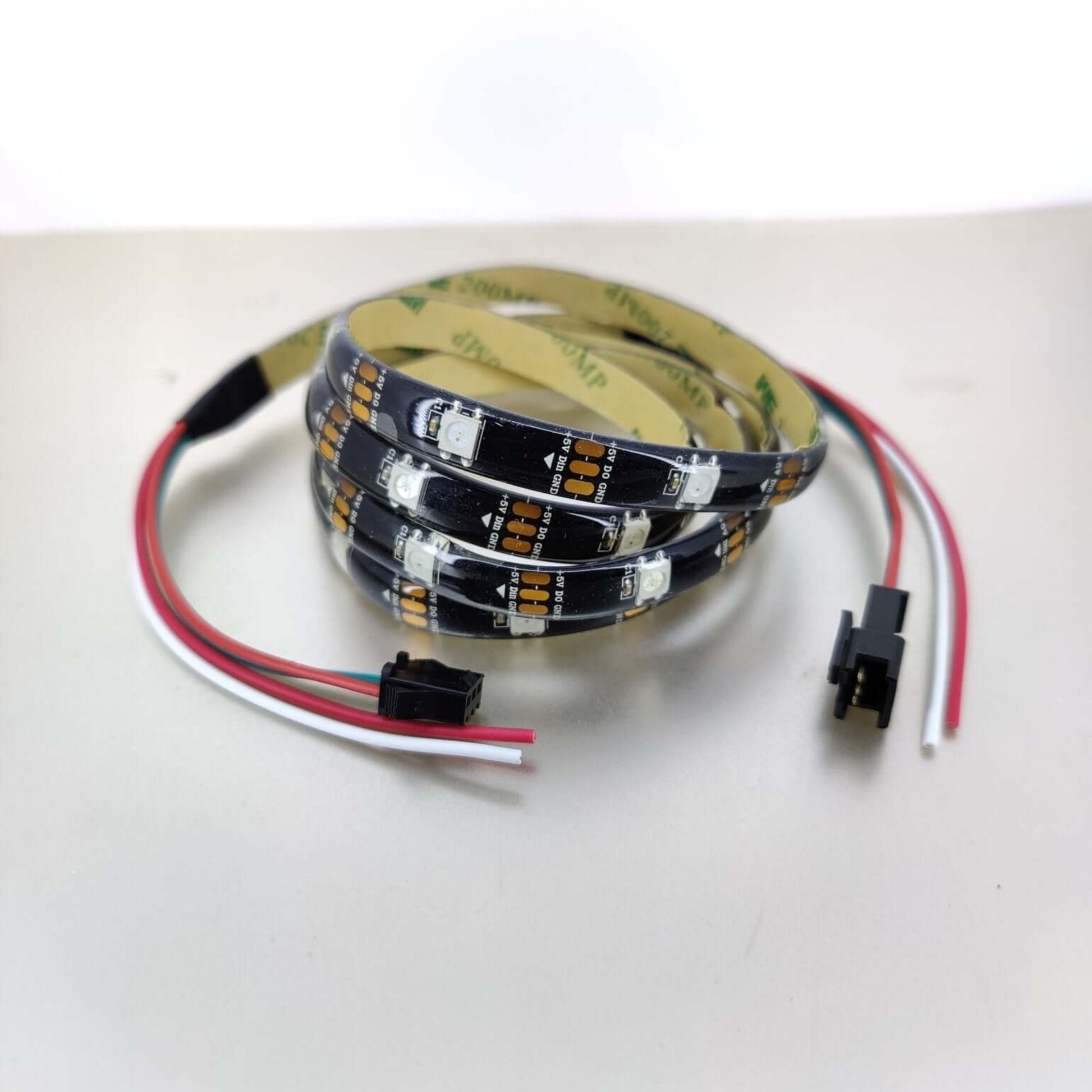 Detailed view of the WS2812B LED strip with 5V power and data input/output connectors.
