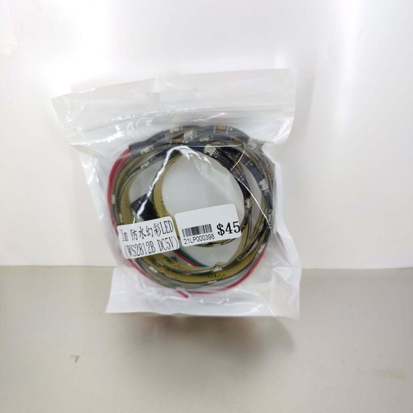 1m WS2812B 5V Addressable LED strip light in bag with price tag. Ideal for DIY projects.